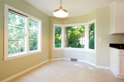 Bright empty dining room interior with tile floor and round corner