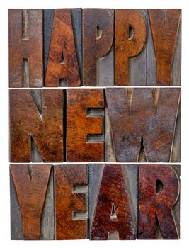 Happy New Year greetings or wishes - a word abstract in vintage letterpress wood type blocks with ink patina