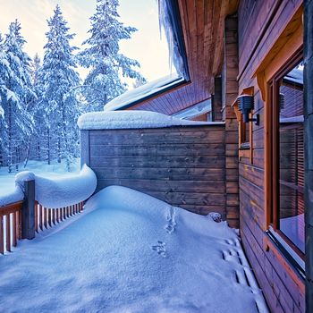 Terrace under snow in forest cottage