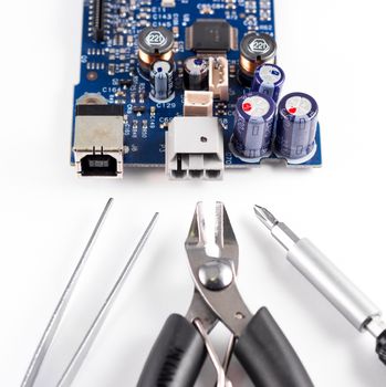 electronic circuit broken and repair tools, pliers, wire cutters and screwdrivers