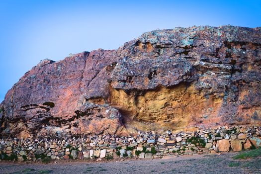 The Rock of the Puma (Titicaca) popular archeological site, a sacred place of the Tiwanaku and Inca cultures, on Isla del Sol (Island of the Sun) in Lake Titicaca, Bolivia photographed at sunset