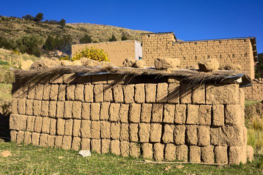 Dried adobe bricks piled upon each other at Lake Titicaca in Bolivia. In and around the small tourist town of Copacabana many houses are built of these mud bricks. 