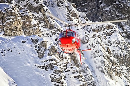 Red helicopter at swiss alps near Jungfrau mountain