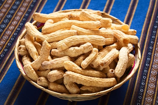 Sweetened popped pasta eaten as snack in Bolivia served in woven basket, , photographed with natural light (Selective Focus, Focus in the middle of the snack) 