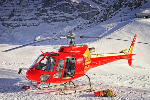 Red helicopter landed at swiss ski resort near Jungfrau mountain