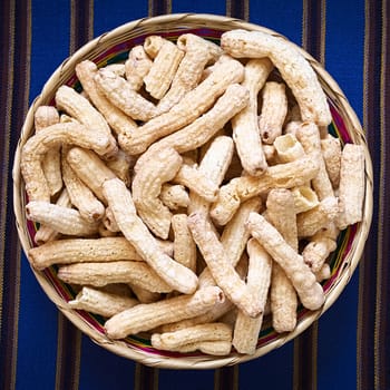 Sweetened popped pasta eaten as snack in Bolivia served in woven basket, photographed with natural light 