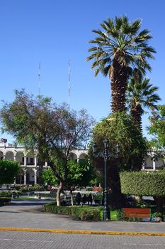 AREQUIPA, PERU - OCTOBER 8, 2014: Plaza de Armas (main square) with the archway of the Portal de las Flores in the back early in the morning on October 8, 2014 in Arequipa, Peru. Arequipa is an UNESCO World Cultural Heritage Site. 