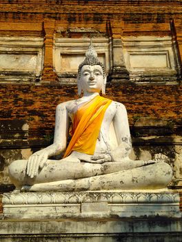 Stone statue of a buddha in ruined old temple at Ayutthaya Thailand