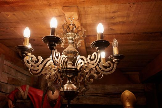Vintage classical brass copper chandelier in a rustic country style house                               