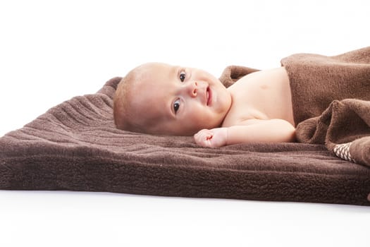 baby boy over brown blanket on white background