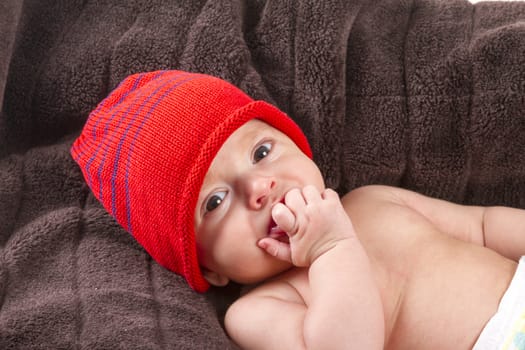 baby boy over brown blanket on white background