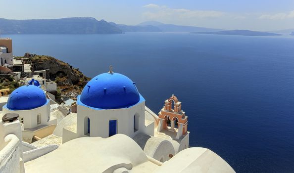 Church domes in Oia by beautiful day, Santorini, Greece