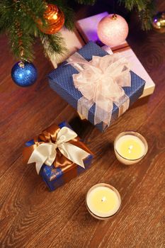 Christmas gift boxes in the interior with two candle