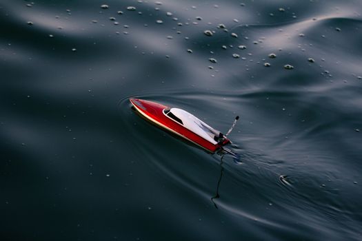 Remote control boat in the blue lake