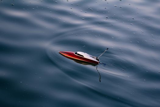 Remote control boat in the blue lake