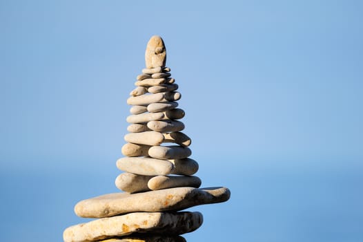 Balancing of white pebbles each other on the seacoast