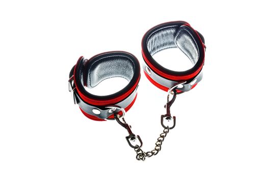 Red leather handcuffs in white background