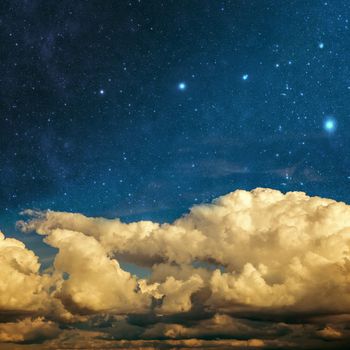 clouds and stars on a textured vintage paper background