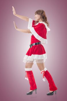 Christmas girl push something, full length pose isolated.