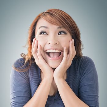 Excited happy Asian girl face, closeup portrait.