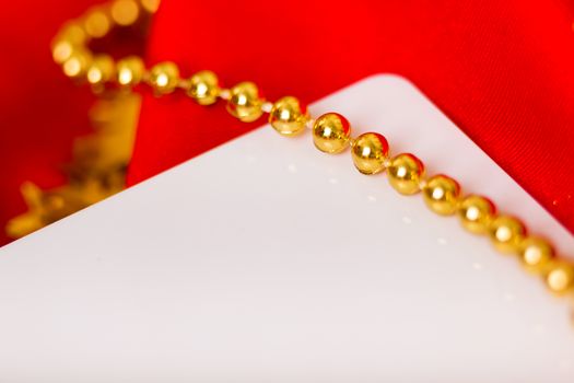 Christmas card. Red fabric with festive beads