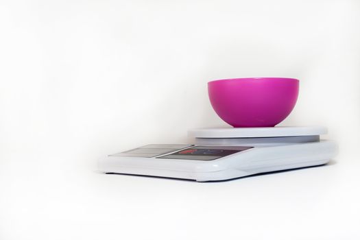 Plastic bowl on the digital kitchen scale.