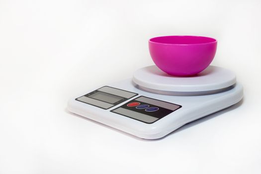 Plastic bowl on the digital kitchen scale.