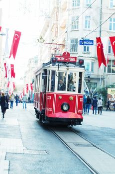 ISTANBUL, TURKEY - SEPTEMBER 21, 2014: The old tram and people walking in Istiklal Caddesi on September 21, 2014 on Istanbul, Turkey.