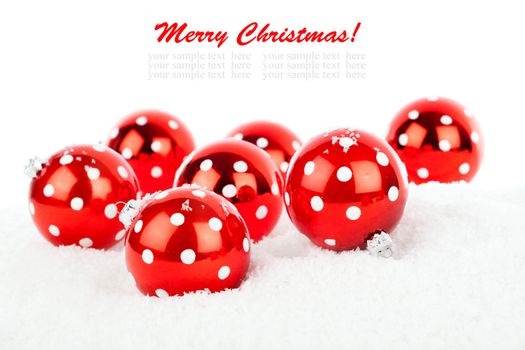 red polka dot Christmas bauble, isolated over white