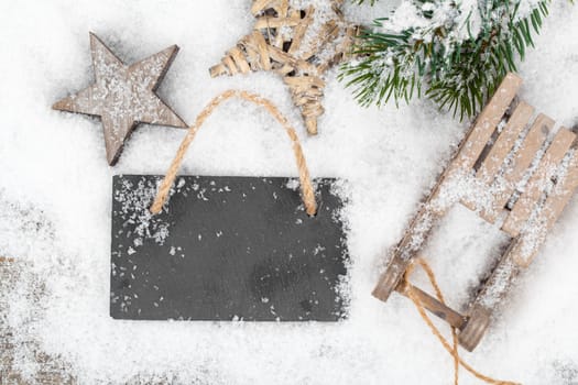 Christmas decoration over snow, wooden background