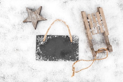 Christmas decoration over snow, wooden background