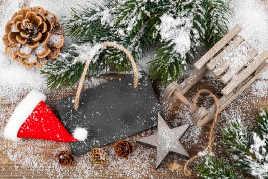 Christmas decoration over snow, wooden background