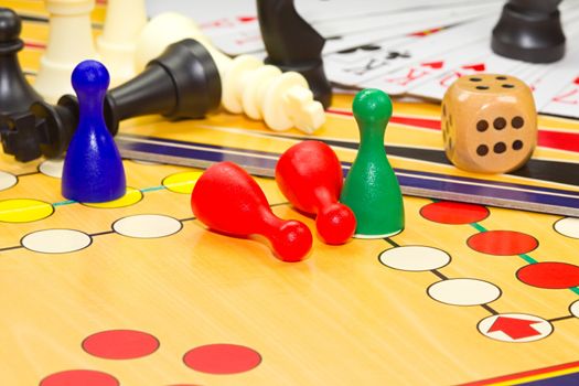 Photo shows a closeup of a various board games including chess and cards.