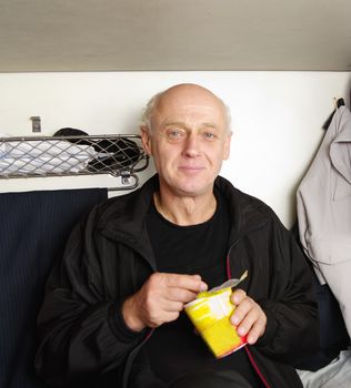 man eating fast food in train