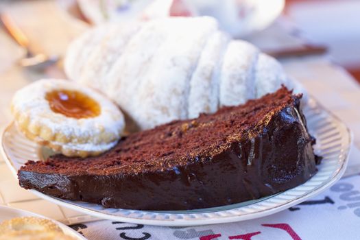 Chocolate cake, biscuit and croissant for breakfast