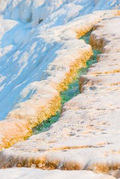 rivulet with turquoise water on the mountain in Pamukkale