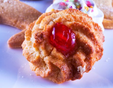 Biscuit with cherry over a white plate