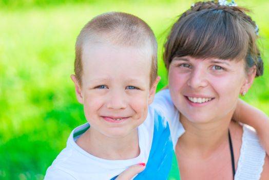 happy woman with a boy of 5 years on the nature