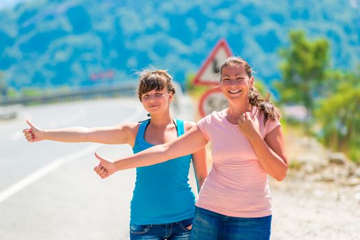 beautiful young girlfriends stopped passing car