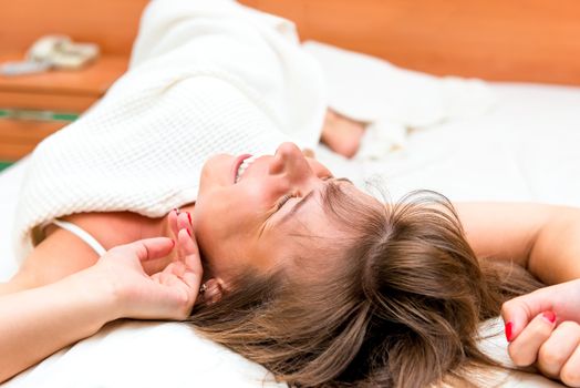 girl stretches awake in bed in the morning