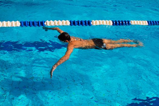 Professional swimmer dives under water in the pool - Stock Image