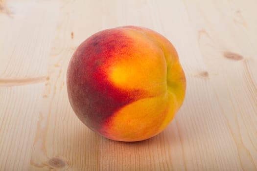 Fresh peaches on a light wood background