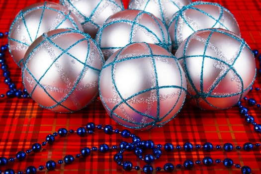 Silver Christmas balls on a red background