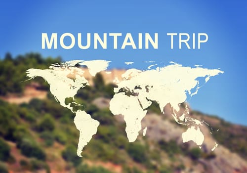 Contoured map of world continents with inscription Mountain Trip, blurred photo of mountain slope as backdrop.