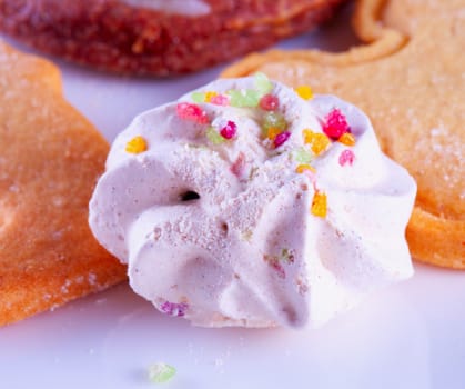 Biscuit spumone between other biscuits over white plate