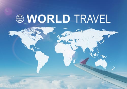 Contoured map of world continents with inscription World Travel and related symbol. Wing of flying jet on foreground, clouds and blue sky and sky as backdrop.