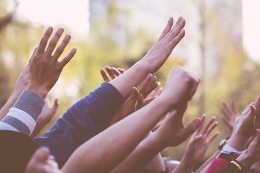 raising  hands  in a crowed of people