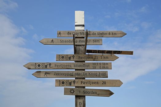 A tower with signs on the beach in Texel