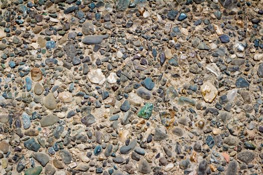 A fragment of a fence made of small colored stones ( the background image).