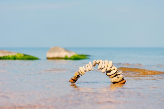 Circle of pebbles on the surface of the sea